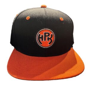 musta lippis oranssilla suoralla lipalla